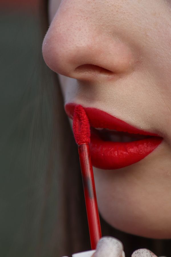 Close-up of red liquid lipstick being applied to lips.
How To Choose The Best Lipstick Colors For Your Skin Tone